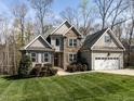 Attractive two-story home featuring stone accents, a two-car garage, and a well-manicured lawn at 1108 Kalworth Rd, Wake Forest, NC 27587