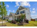 A front corner of the house showing stone accents and a well manicured lawn at 115 Bourne Dr, Franklinton, NC 27525