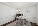 A minimal home office with white walls, a simple desk, and a comfortable chair at 115 Bourne Dr, Franklinton, NC 27525