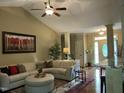 Comfortable living room featuring a plush sectional sofa, hardwood flooring, and an open layout at 115 Oak Leaf Trl, Youngsville, NC 27596
