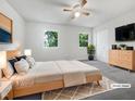 Spacious main bedroom with two windows, neutral colors, and a ceiling fan at 122 Mallard Ct, Chapel Hill, NC 27517
