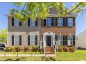 Charming two-story home with a brick and siding facade and manicured lawn at 1220 Marbank St, Wake Forest, NC 27587