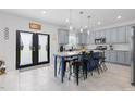 Bright kitchen featuring a central island, modern appliances, and direct access to the backyard at 1220 Marbank St, Wake Forest, NC 27587