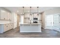 Bright kitchen featuring a large center island, stainless steel appliances, and modern pendant lighting at 1234 Pioneer Lot 3 Dr, Sanford, NC 27330