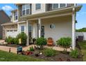 Inviting front porch with wood chairs and lush landscaping, perfect for enjoying outdoor living at 135 Campaign Dr, Mebane, NC 27302