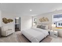 The main bedroom features carpet, neutral paint, an ensuite bathroom, and natural light at 141 Gladstone Loop, Clayton, NC 27520