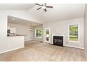 Spacious living room features vaulted ceilings, a cozy fireplace, and access to the outdoor deck at 175 Grist Mill Dr, Franklinton, NC 27525