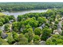 Lush community with lake views features tree-lined streets and well-maintained homes at 206 Swiss Lake Dr, Cary, NC 27513