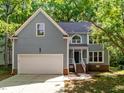 Charming two-story home with attached two-car garage, dormer, and well-manicured lawn at 206 Swiss Lake Dr, Cary, NC 27513