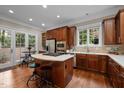 Gourmet kitchen with a center island cooktop, stainless steel appliances, and a cozy breakfast nook at 213 Old Franklin Grove Dr, Chapel Hill, NC 27514