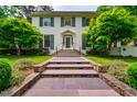Charming two-story home with a welcoming front entrance, stone walkway, and well-maintained landscaping at 220 Glandon Dr, Chapel Hill, NC 27514