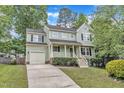 Inviting two-story home featuring a classic front porch and well-maintained landscaping for enhanced curb appeal at 221 Mint Hill Dr, Cary, NC 27519