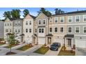 Attractive townhomes in neutral colors featuring attached garages and well maintained landscaping at 2617 Chert Ln, Raleigh, NC 27610