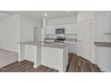 Bright kitchen featuring granite countertops, stainless steel appliances, and a functional island, perfect for cooking and entertaining at 280 Babbling Brook Dr, Clayton, NC 27520