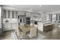 Open-concept kitchen and dining area with stainless steel appliances, a large island, and stylish decor at 2885 Foster Woods Dr, Apex, NC 27502