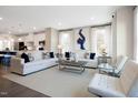 Spacious living room with plush white sofas, stylish decor, and an open view of the adjacent kitchen at 2889 Foster Woods Dr, Apex, NC 27502