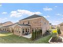 Spacious backyard featuring a patio with furniture and well-maintained landscaping at 330 Macallan Dr, Burlington, NC 27215