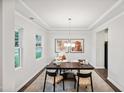 Bright home office with a dark wood desk, stylish chairs, neutral rug, and large window for natural light at 4024 Shadbush St, Raleigh, NC 27616
