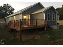 Rear of the home showcasing a large wooden deck, blue siding, and well-maintained landscaping at 405 Starrett Ct, Raleigh, NC 27603
