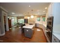Open kitchen featuring a large island, ample counter space, modern appliances, and a view of the dining area at 423 Oakland Dr, Raleigh, NC 27609