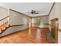 Open living room area features fireplace, wood floors, and natural lighting at 4420 Tetbury Pl, Raleigh, NC 27613