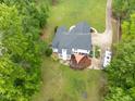 Aerial view of home with a back deck, large yard, and parking for an RV at 4612 River Farm Rd, Rocky Mount, NC 27803