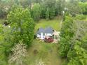 Aerial view of home featuring a large deck and sprawling green lawn with mature trees at 4612 River Farm Rd, Rocky Mount, NC 27803