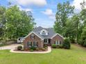 Charming brick home featuring mature landscaping, green lawn and neutral colors at 4612 River Farm Rd, Rocky Mount, NC 27803