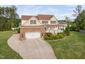 Charming two-story home boasts a manicured lawn, a brick-accented garage, and a welcoming front porch at 48 Falling Oak Ct, Clayton, NC 27520