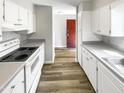 Bright kitchen featuring white cabinetry, modern countertops, and sleek appliances at 5078 Flint Ridge Pl, Raleigh, NC 27609
