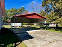 Spacious metal carport providing covered parking for vehicles at 543 Stockyard Rd, Staley, NC 27355