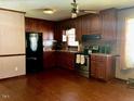 Kitchen features wood cabinets, a black refrigerator and updated appliances at 543 Stockyard Rd, Staley, NC 27355