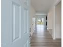 Inviting entryway with light wood-look floors and a view into the open floor plan at 567 Winding Creek Dr, Lillington, NC 27546