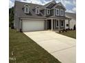 Beautiful two-story home featuring a spacious driveway and well-maintained front lawn at 567 Winding Creek Dr, Lillington, NC 27546