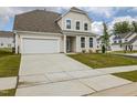 Beautiful two-story home boasting an attached two-car garage and a well-maintained lawn at 567 Winding Creek Dr, Lillington, NC 27546