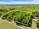 Aerial view shows property lines around a wooded lot with a house on one corner at 606 Dennys Store Rd, Roxboro, NC 27574