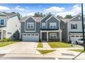 Inviting two-story home showcasing a well-kept front yard, attached garage, and appealing exterior at 608 Cormiche Ln, Wake Forest, NC 27587