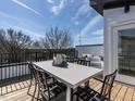 Outdoor rooftop deck with seating and dining options perfect for entertaining at 611 Walnut Hts Dr # 101, Raleigh, NC 27610
