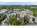 Beautiful aerial view showcasing lush surrounding trees and brick apartment building with rooftop features and street views at 618 N Boylan Ave # 400, Raleigh, NC 27603