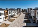 Scenic street view of modern townhouses featuring landscaped yards and inviting exteriors at 620 Walnut Heights Dr # 103, Raleigh, NC 27610