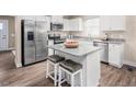 Modern kitchen with stainless steel appliances, granite countertops and an island with seating at 70 Saintsbury Dr, Fuquay Varina, NC 27526