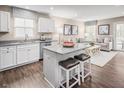 Open-concept kitchen and living room with hardwood floors and plenty of natural light at 70 Saintsbury Dr, Fuquay Varina, NC 27526