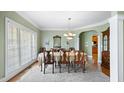 Elegant dining room with large windows, hardwood floors, and traditional decor at 1004 Dunleigh Dr, Burlington, NC 27215