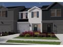 Charming two-story townhome featuring a light gray exterior, blue shutters, and a welcoming front yard at 1045 Winding Spring Dr, Mebane, NC 27302