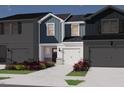 New construction townhome showing the exterior, landscaping, driveway and garage with blue and gray color scheme at 1049 Winding Spring Dr, Mebane, NC 27302