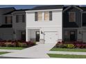 Newly built townhome with a front lawn and landscaping that adds to the curb appeal at 1051 Winding Spring Dr, Mebane, NC 27302