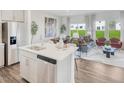 Open concept living area with stainless steel appliances, dining area, and an abundance of natural light at 1051 Winding Spring Dr, Mebane, NC 27302