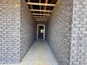 A view of a concrete walkway going through a brick facade to the front door of a home at 1085 Fairhaven Dr # 49, Mebane, NC 27302