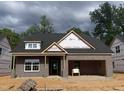 New construction home featuring a brick facade and a garage under construction at 1085 Fairhaven Dr # 49, Mebane, NC 27302