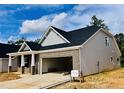 Inviting single-story home with a brick-accented front, an attached two-car garage, and sleek siding at 1085 Fairhaven Dr # 49, Mebane, NC 27302